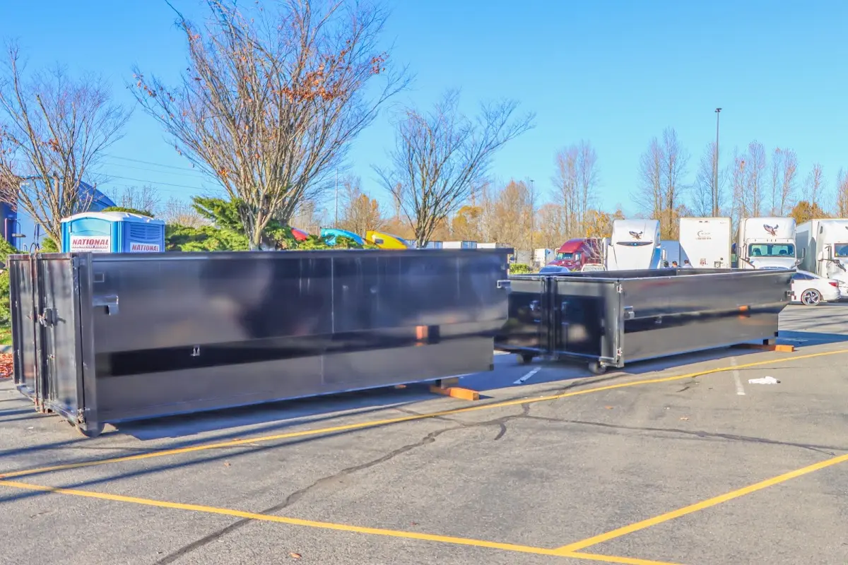 Professional dumpster rental service with roll-off container on residential driveway in Oceanside